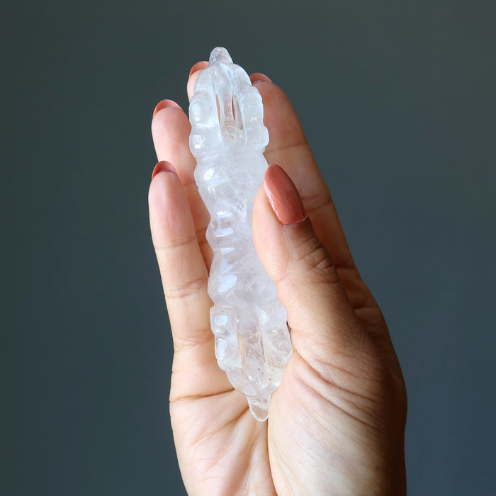 hand holding clear quartz dorje wand