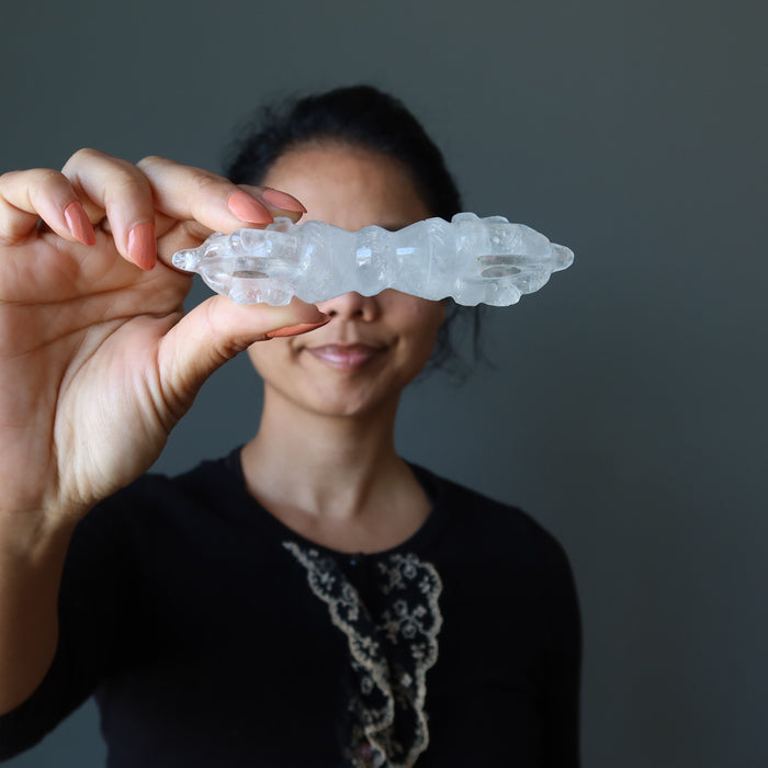 hand holding clear quartz dorje wand