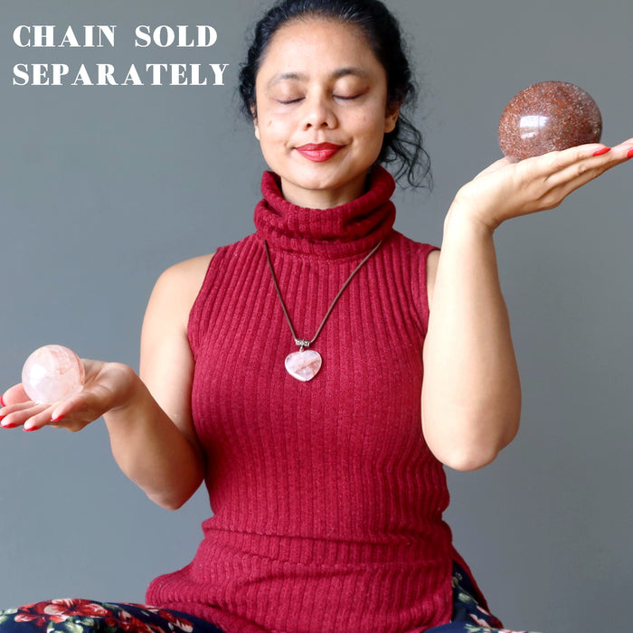 sheila of satin crystals meditating with red quartz spheres and wearing a red quartz heart pendant, chain sold separately