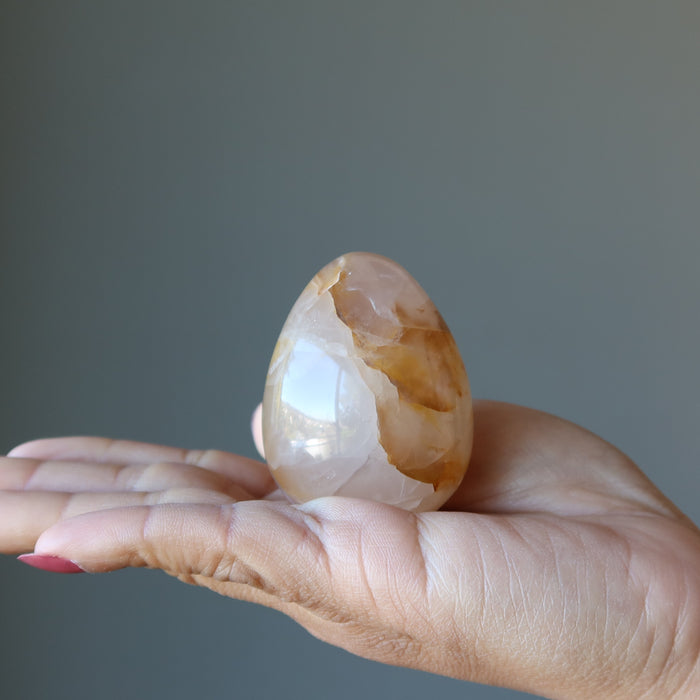 Golden Quartz Egg on the palm