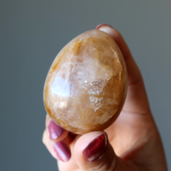 hand holding Golden Quartz Egg