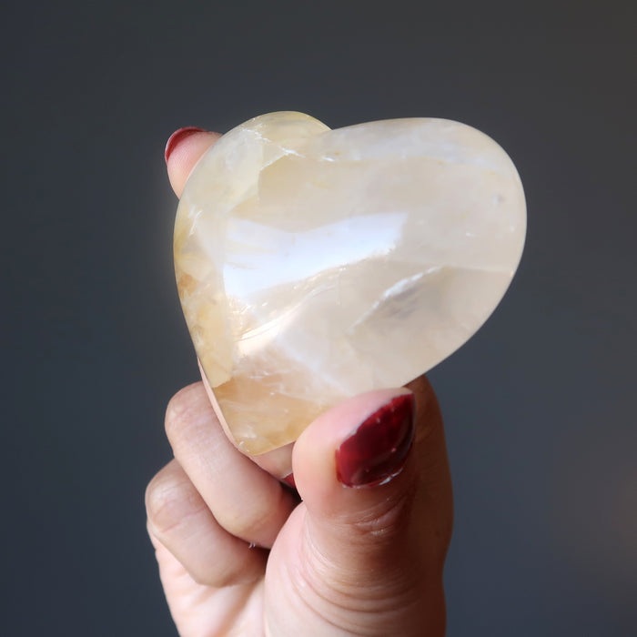 holding Golden Milky Hematoid Quartz Heart