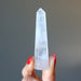 holding faceted Cloud Quartz Wand 