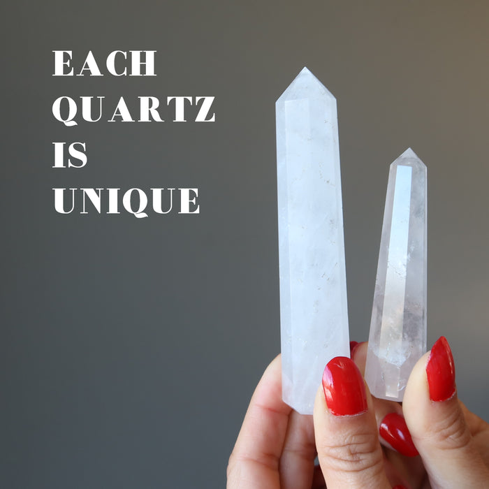 holding two unique faceted Cloud Quartz Wands