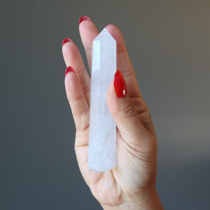 hand holding faceted Cloud Quartz Wand 