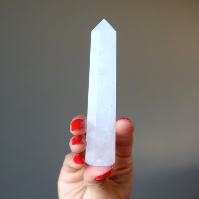 holding faceted Cloud Quartz Wand 