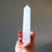 holding faceted Cloud Quartz Wand 