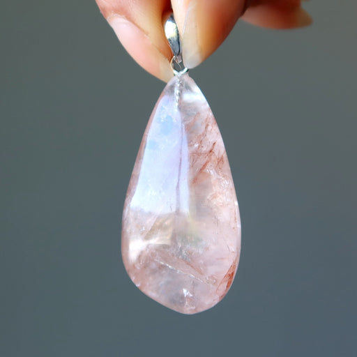 clear quartz with red fire inclusions in teardrop pendant 