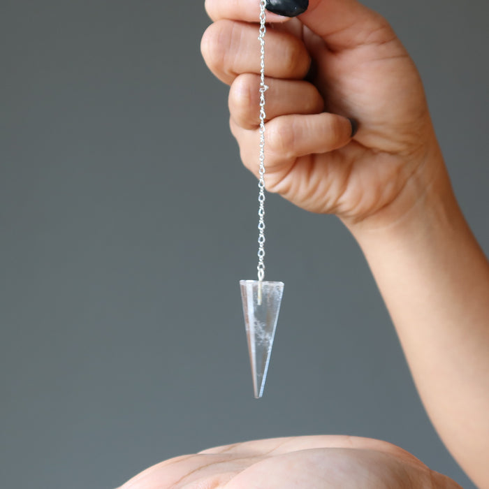 hand dowsing with a clear quartz pendulum