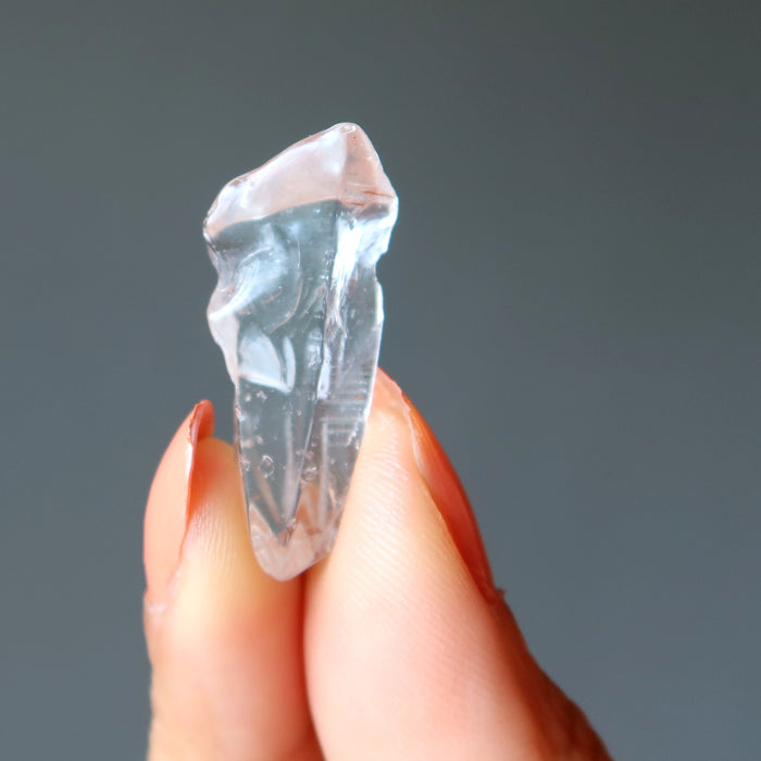 holding Raw Clear Quartz Point
