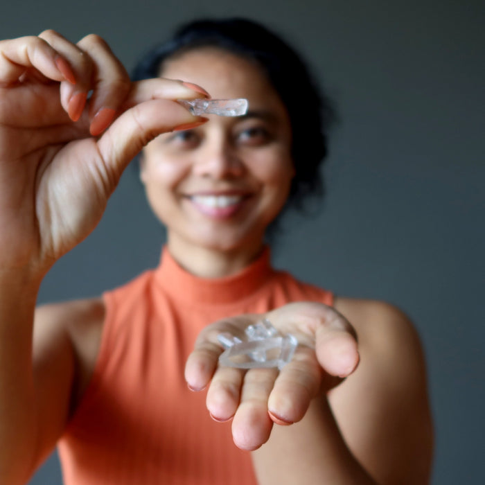 sheila of satin crystals holding Raw Clear Quartz Points 