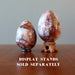 red quartz eggs on display stands