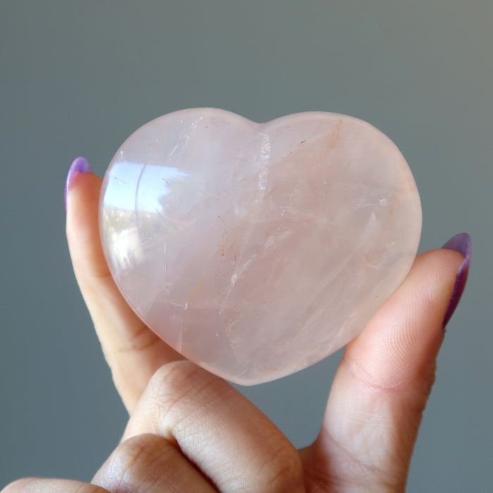 hand holding red fire quartz heart