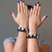 sheila of satin crystals wearing 4 white quartz and black obsidian round beaded stretch bracelets