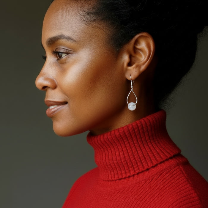 woman modeling snow quartz dangle earrings