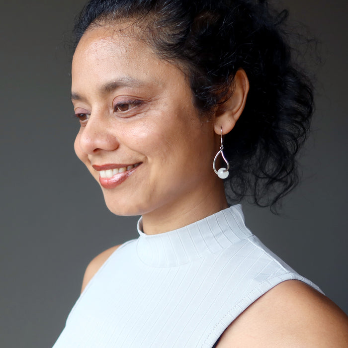 woman modeling snow quartz dangle earrings