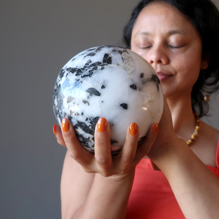 sheila of satin crystals meditating with a quartz tourmaline crystal ball