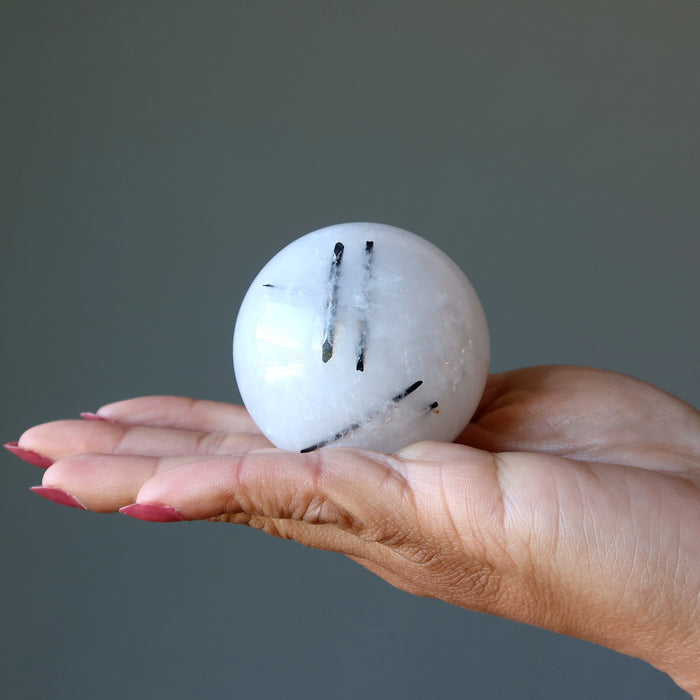 quartz tourmaline sphere in hand