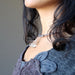 female wearing quartz cage necklace