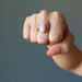 hand wearing pink rhodochrosite oval in adjustable copper ring
