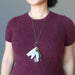 woman wearing rhodonite key necklace