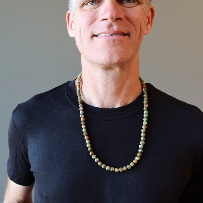 man wearing rhyolite necklace