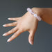 hand wearing clear pink rose quartz round beaded stretch bracelet