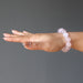 hand wearing clear pink rose quartz round beaded stretch bracelet