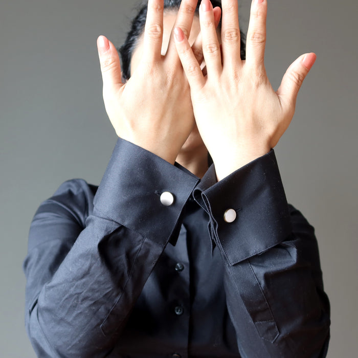 woman wearing rose quartz antique bronze cufflinks on black cufflink shirt