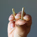 hand holding rose quartz gold cufflinks