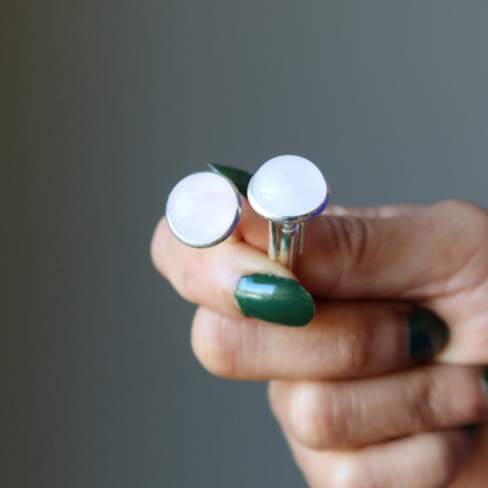 hand holding rose quartz silver cufflinks