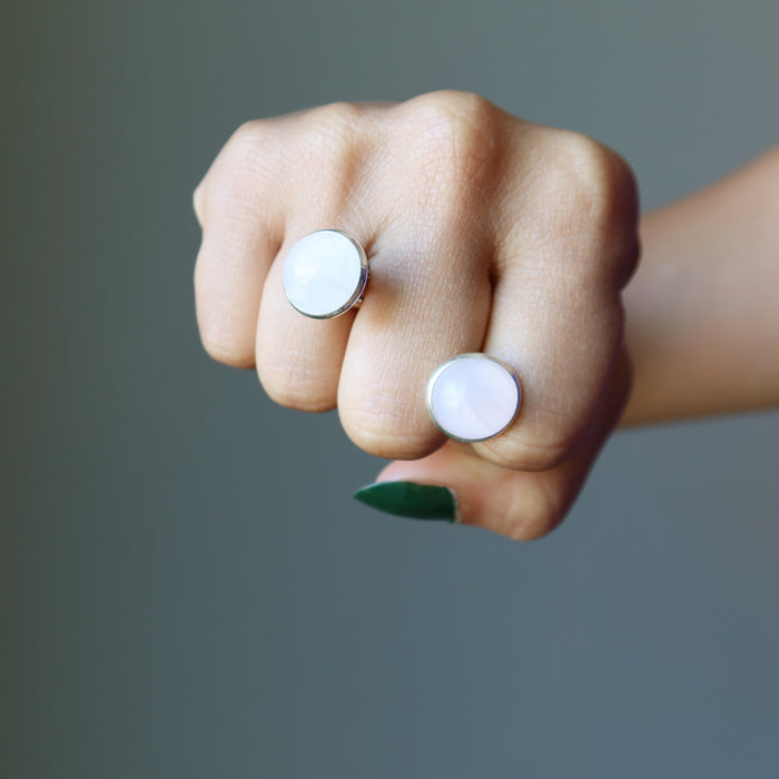 hand holding rose quartz silver cufflinks