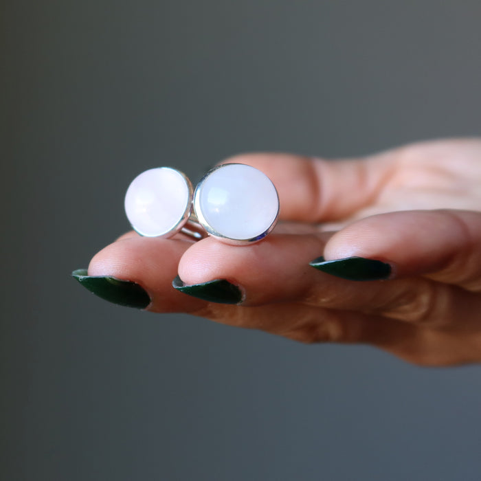 hand holding rose quartz silver cufflinks
