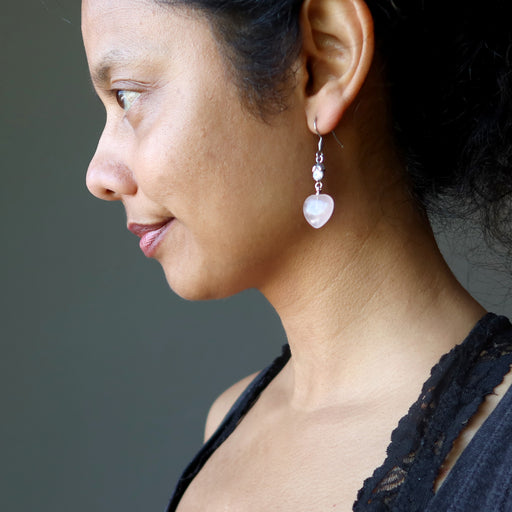 sheila of satin crystals wearing rose quartz heart earrings with sparkling crystal accents 