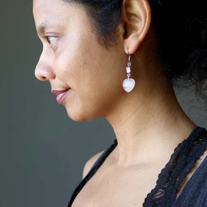 sheila of satin crystals wearing rose quartz heart earrings with sparkling crystal accents 