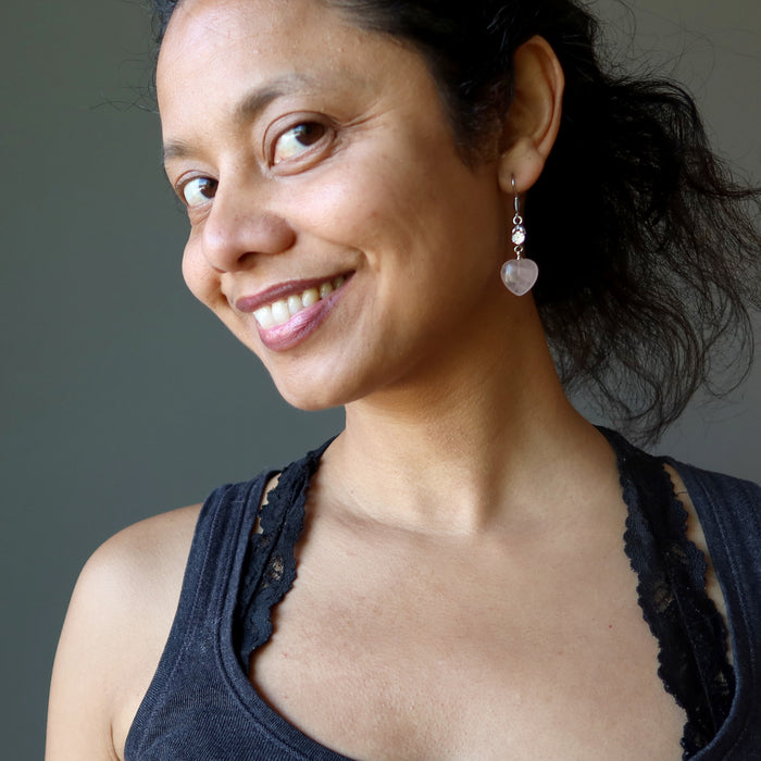 sheila of satin crystals wearing rose quartz heart earrings with sparkling crystal accents 
