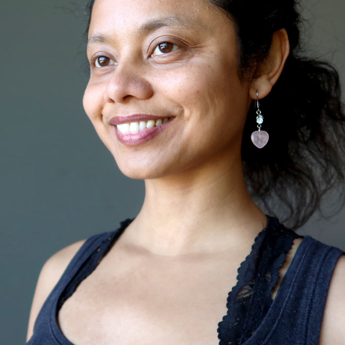sheila of satin crystals wearing rose quartz heart earrings with sparkling crystal accents 