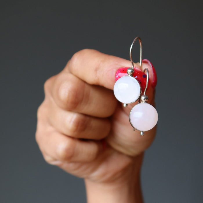 hand holding pink rose quartz sterling silver earrings