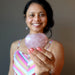 woman holding a pink rose quartz crystal heart
