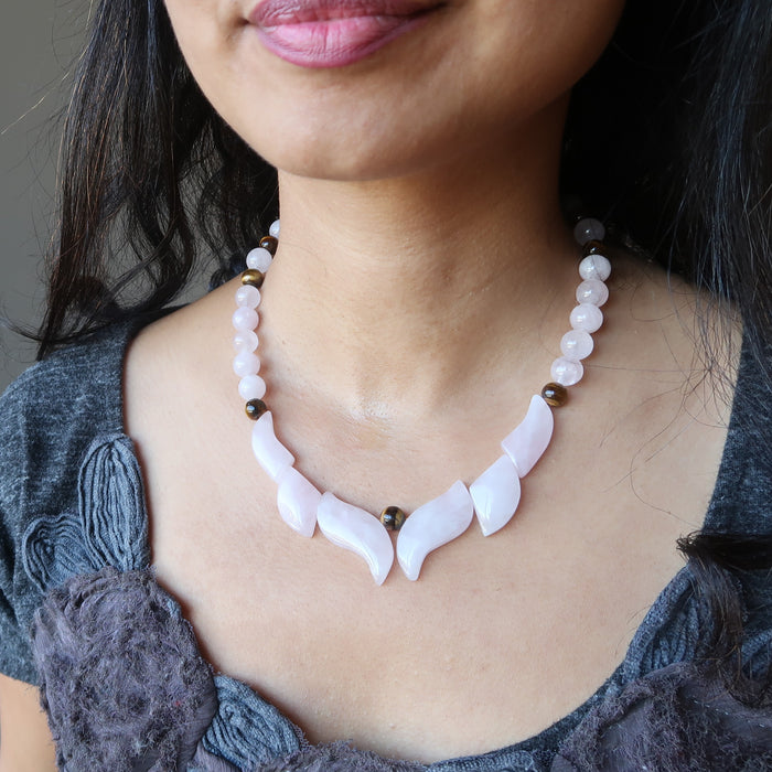 rose quartz flame necklace on female neck