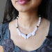 rose quartz flame necklace on female neck