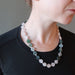 woman modeling a rose quartz moss agate flower necklace