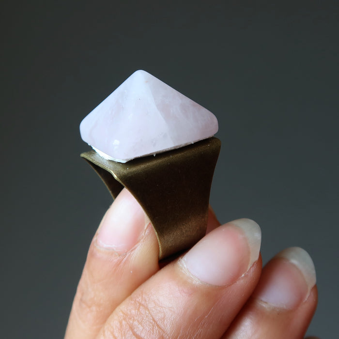 hand holding rose quartz pyramid ring