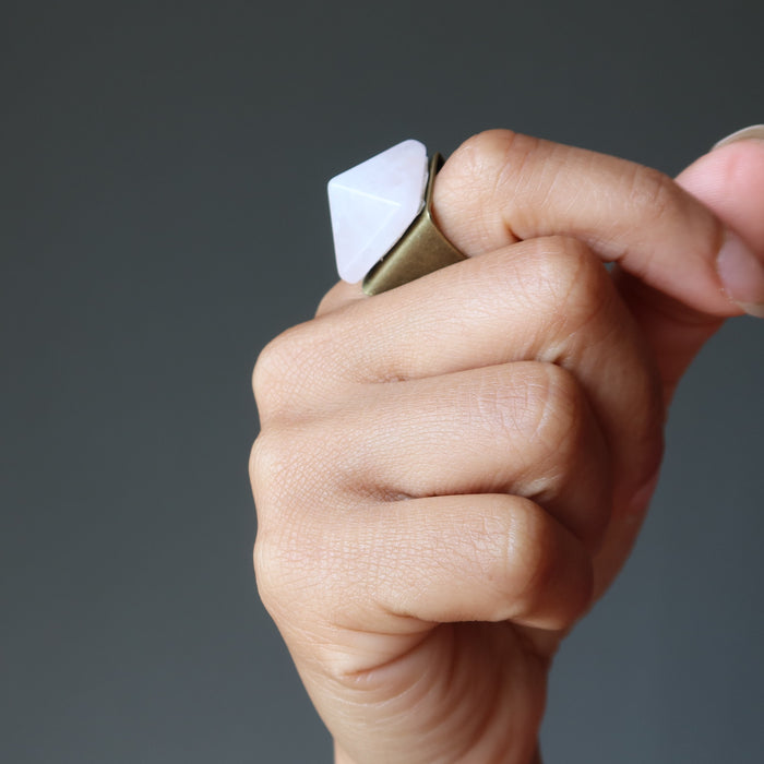 hand wearing rose quartz pyramid ring