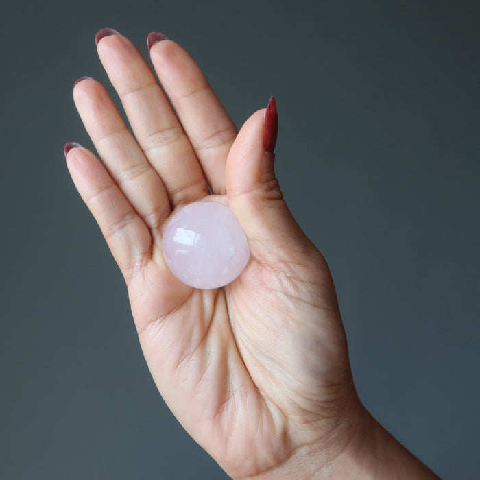 rose quartz sphere in palm of hand