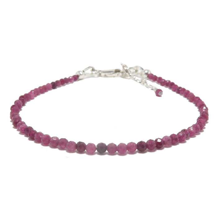 A sterling silver bracelet featuring a series of round red ruby faceted beads, secured with a lobster claw clasp.