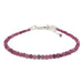 A sterling silver bracelet featuring a series of round red ruby faceted beads, secured with a lobster claw clasp.