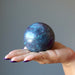 hand holding ruby kyanite sphere