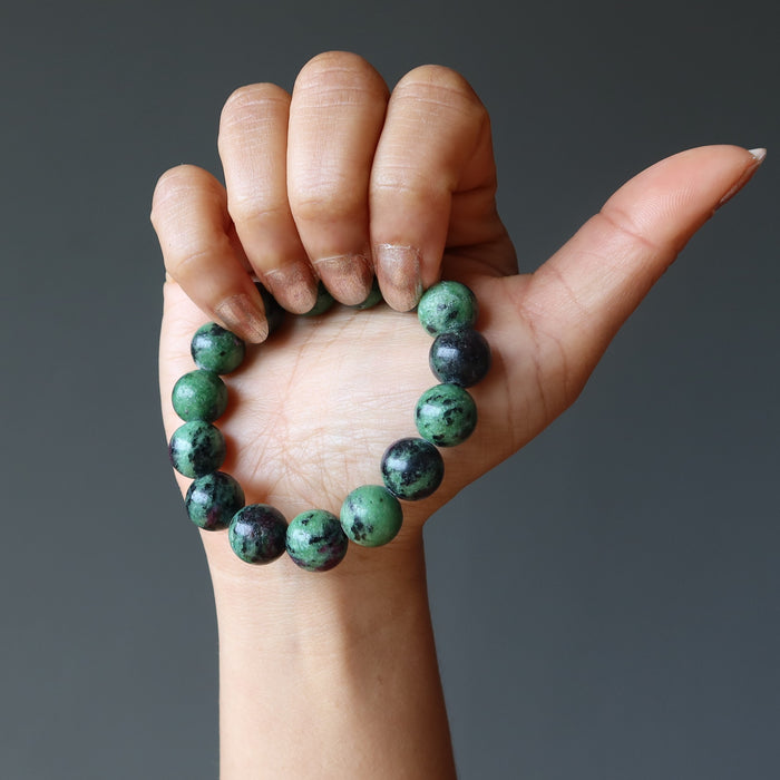 hand wearing a ruby zoisite round stretch bracelet
