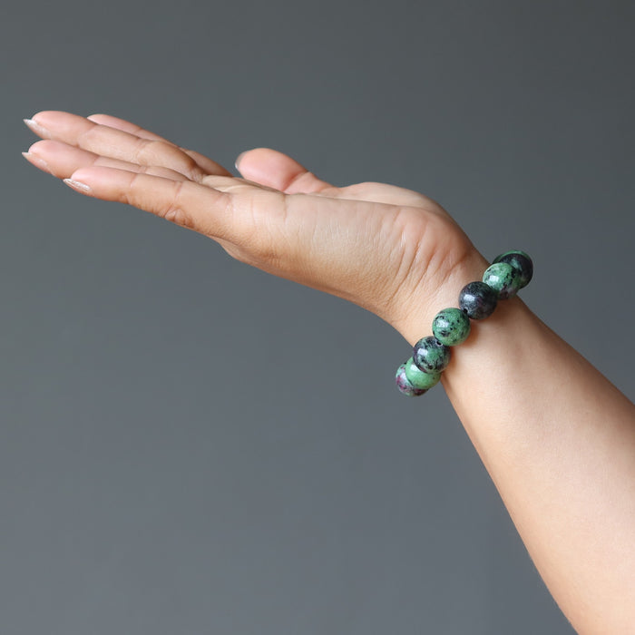 hand wearing a ruby zoisite round stretch bracelet
